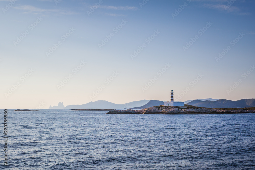 Beautiful view of the silhouette of Ibiza lighthouse taken from the sea