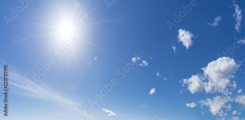 Background with sun and clouds on blue sky at summer