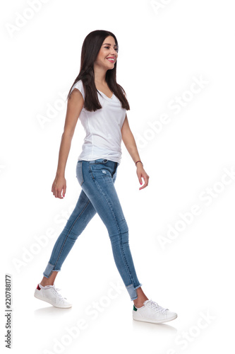 sexy casual woman wearing a white t-shirt walking to side