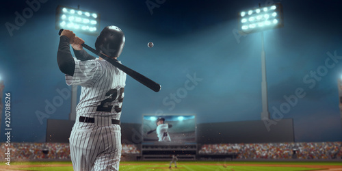 Baseball player bat the ball on professional baseball stadium photo