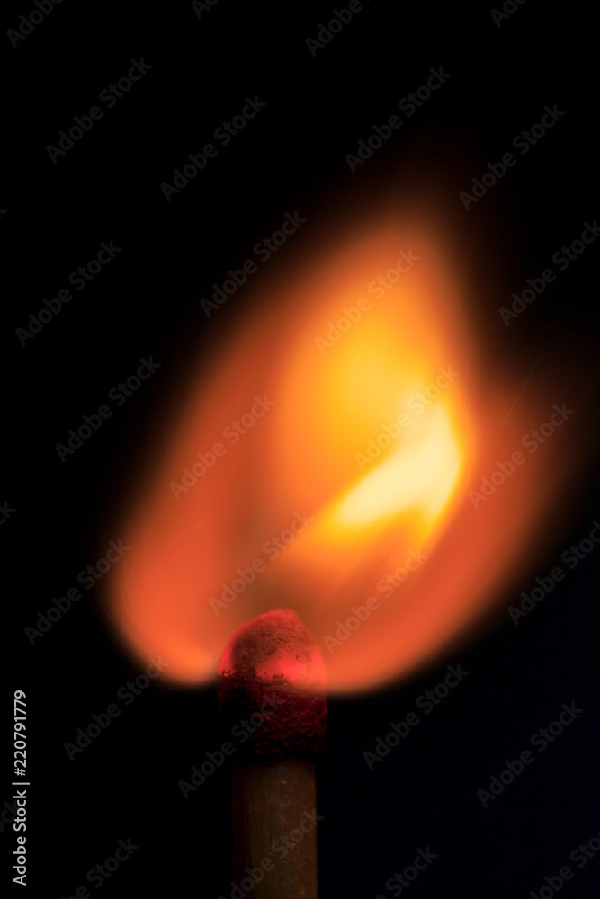 burning match in the dark / match fire on a black background close-up burning match in the dark / match fire on a black background close-up