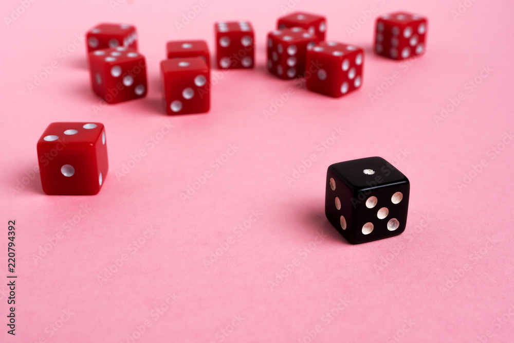 Red and black gaming dices on pink background. Game concept. Red and black gaming dices on pink background. Game concept.