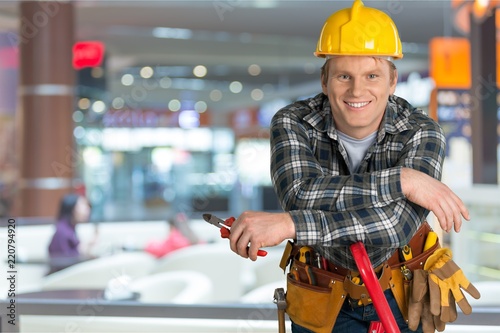 Male worker with tool belt isolated on   background