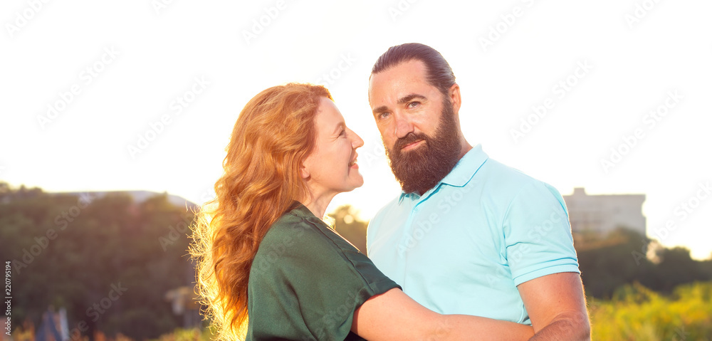 Happy adult couple man and woman on sunset background. Happy adult couple man and woman on sunset background.