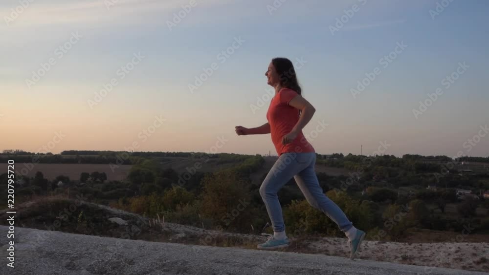Girl Runs up the Mountain, morning Exercising for health, slow motion, steadicam Girl Runs up the Mountain, morning Exercising for health, slow motion, steadicam
