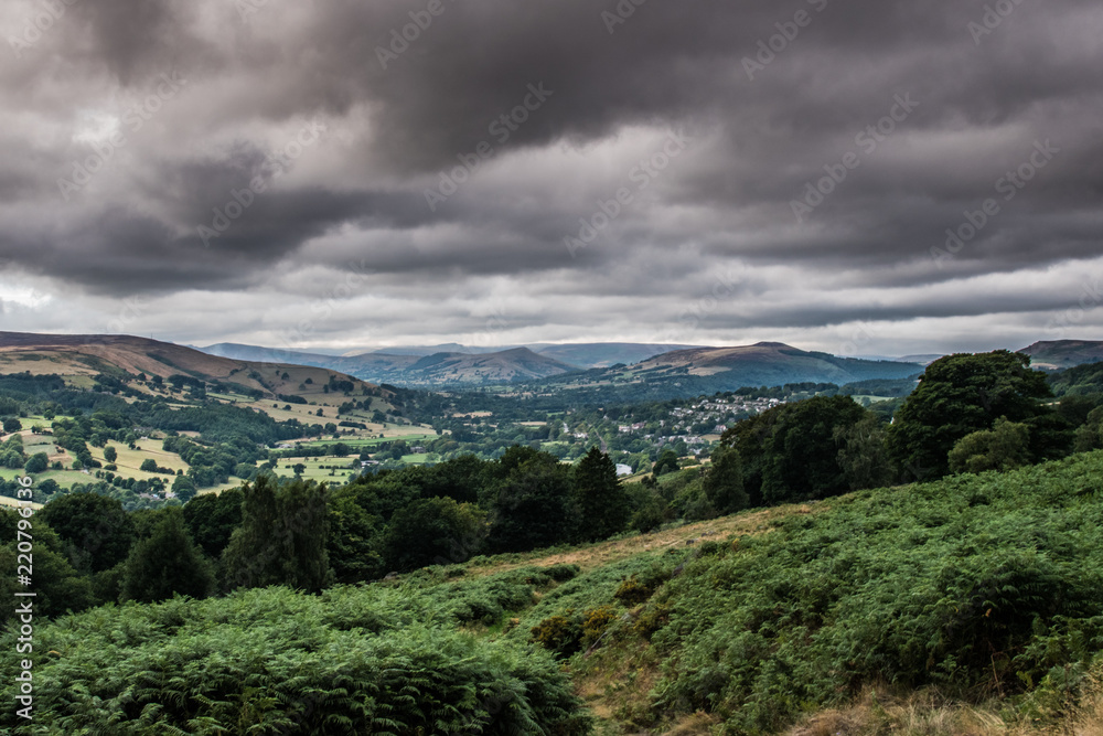Naklejka premium Dark clouds over the hills and landscape