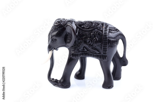 Black Engraved pattern gold elephant made of resin like wooden carving with white ivory. Stand on white background, Isolated, Art Model Thai Crafts, For decoration Like in the spa. 