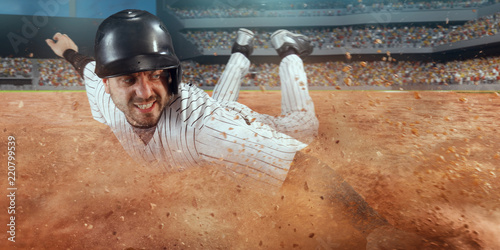 Photography Baseball runner slide to the second base on professional baseball stadium