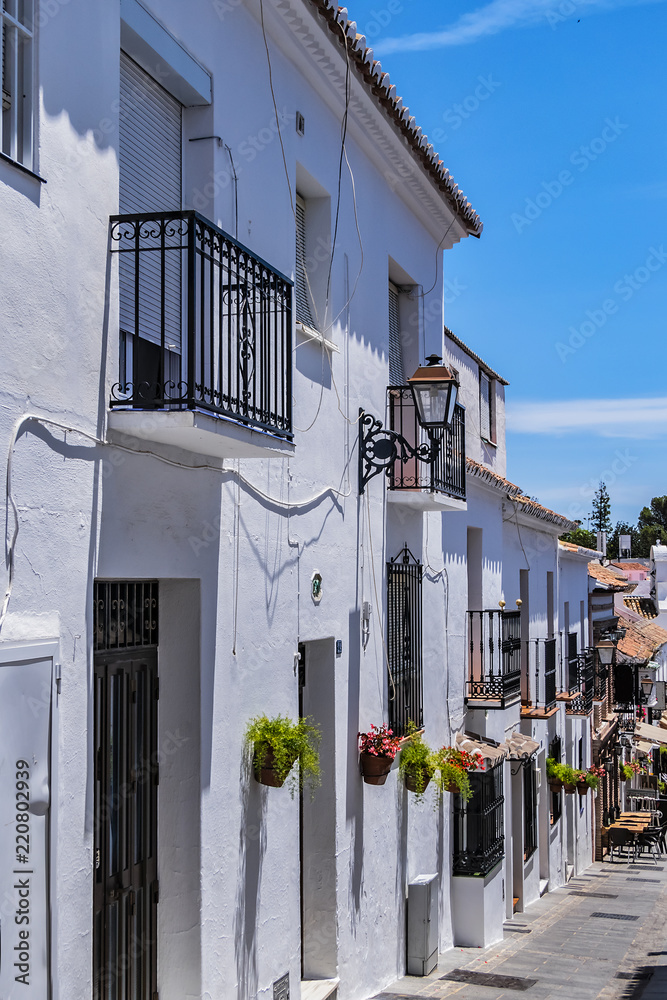 Picturesque San Sebastian Street (Calle San Sebastian) in Spanish hill town overlooking the Costa del Sol, known for its white-washed buildings. Mijas, Andalusia, Spain.