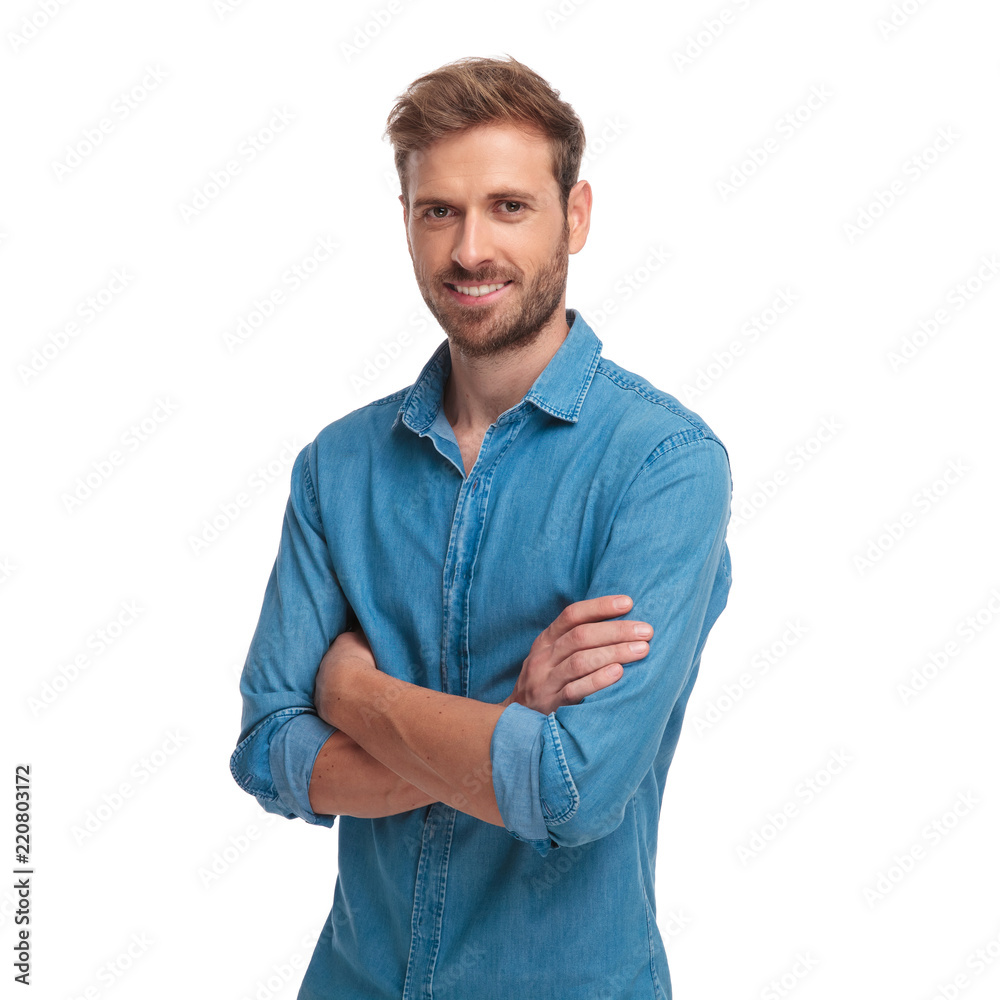 young smiling casual man standing with hands crossed - obrazy, fototapety, plakaty 