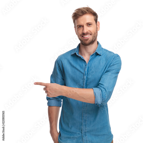 young casual studnt points finger to side