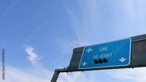 airplane flying over lima airport signboard photo