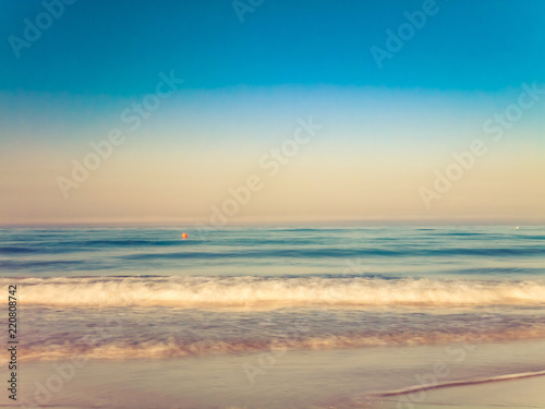 motion blurred gentle waves splashing in the morning on the sand beach © Algecireño