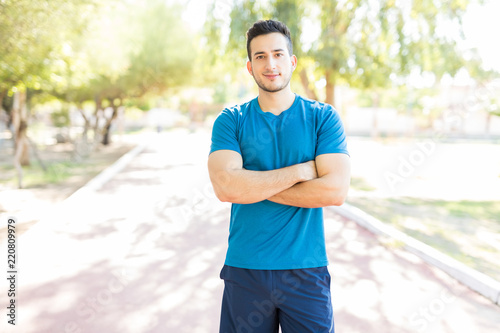 Young Man Standing Arms Crossed Before Workout In Park