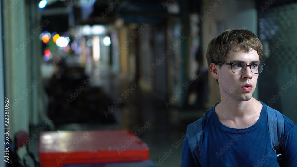 Casually Dressed Young Caucasian Man Walking in Dangerous, Dark Alley Way - Model Released