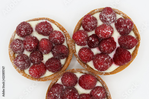 Wallpaper Mural Three tartlets with raspberry on white background Torontodigital.ca