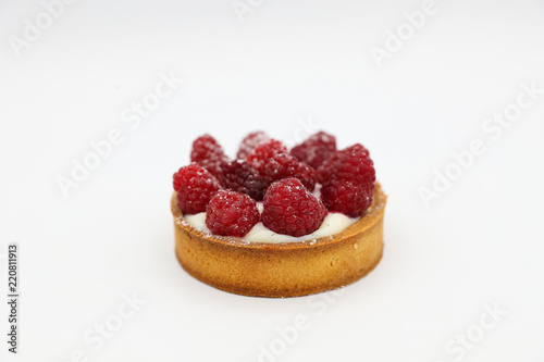Tartlet with raspberry on white background