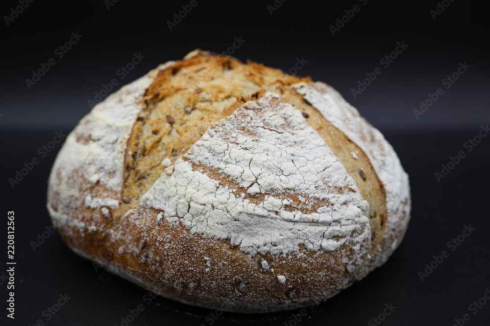 Fresh bread with seasonings on a dark background