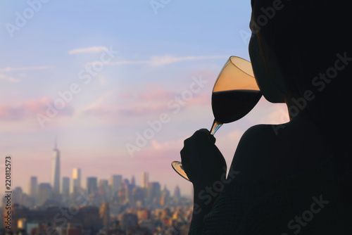 Photography Female hand with glass of wine on Manhattan background
