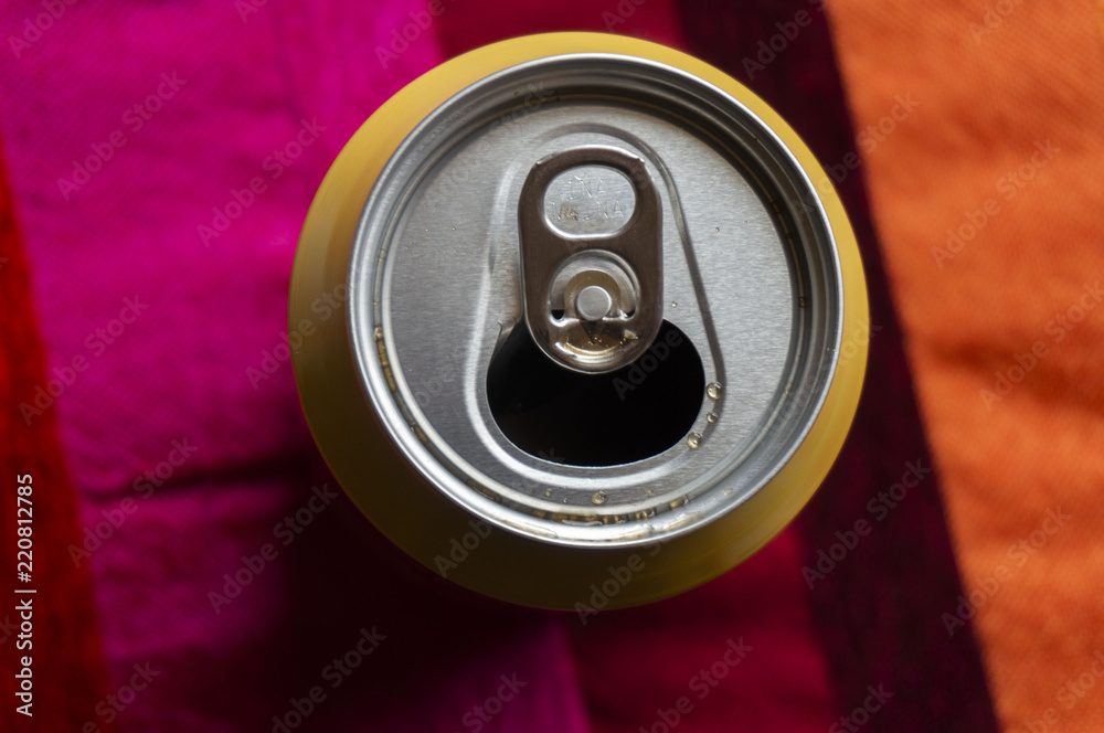 Opened can with sparkling drink isolated on coloured background Opened can with sparkling drink isolated on coloured background