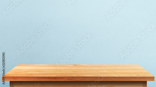 Fotografi Empty wooden tabletop isolated on blue wall background