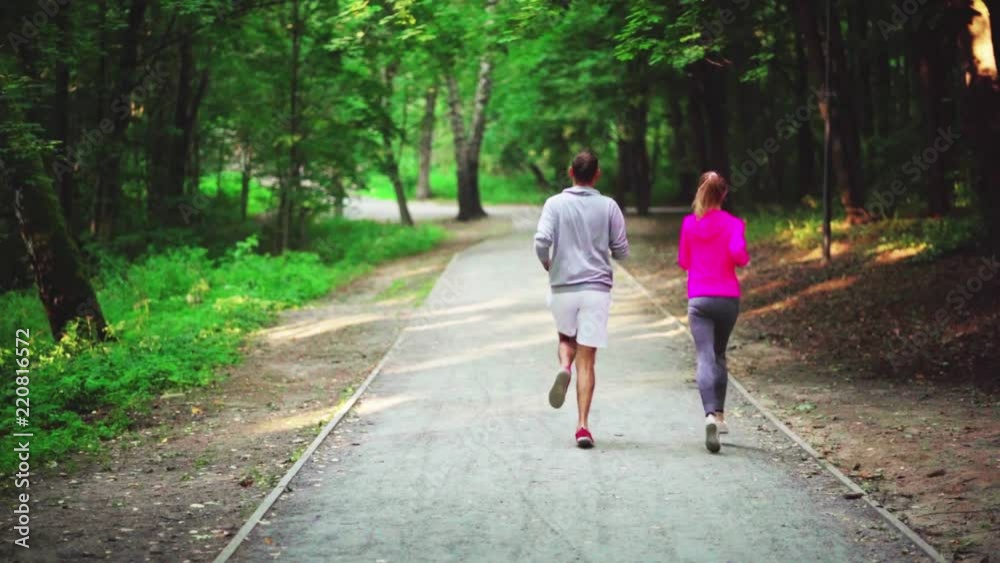 A girl and a man are engaged in a sport A girl and a man are engaged in a sport