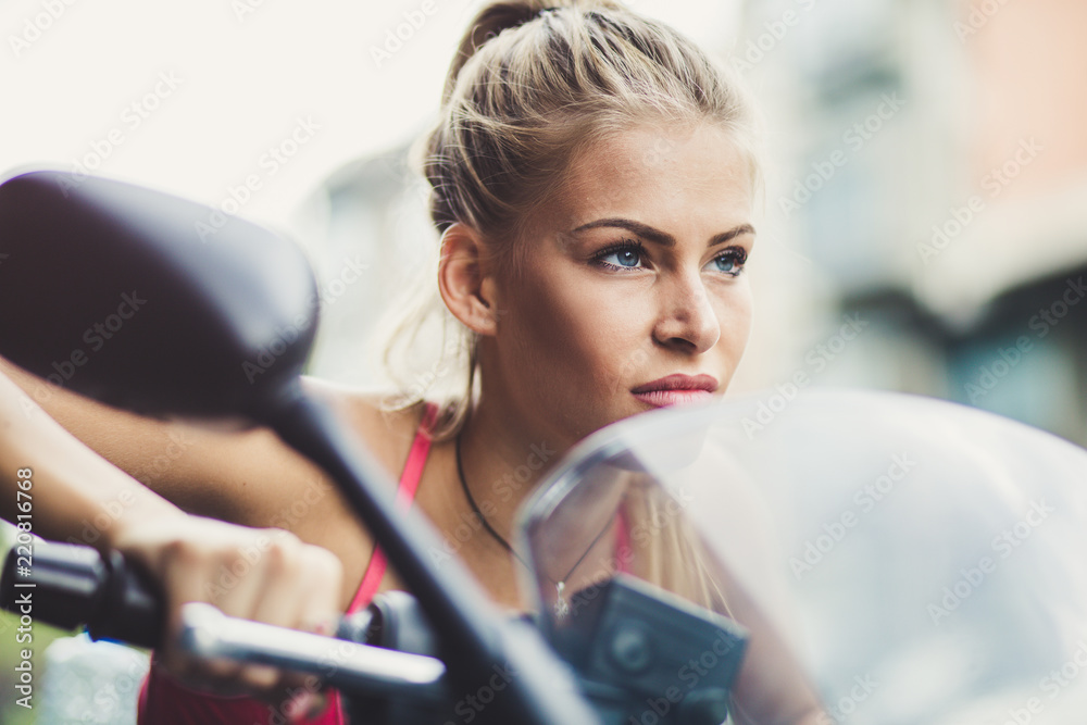 © liderina - Young blonde women ride a motorcycle.  Portrait.  Close up.