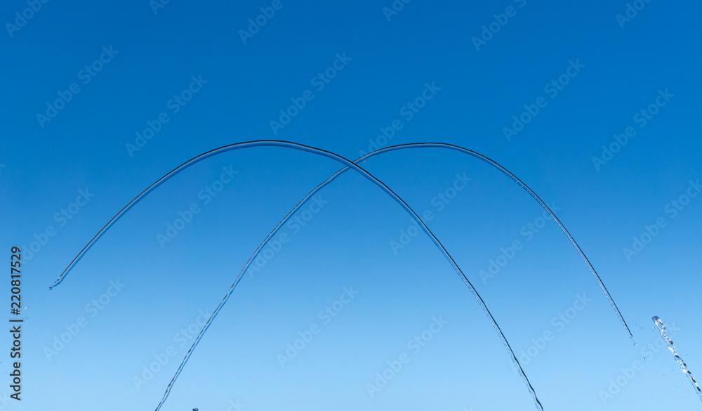 Streams and drops of water on a blue background Streams and drops of water on a blue background