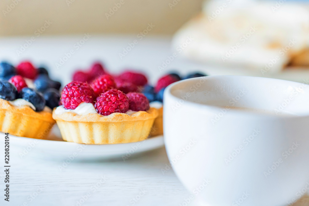 Sweet tarts with mixed berries on a plate Sweet tarts with mixed berries on a plate