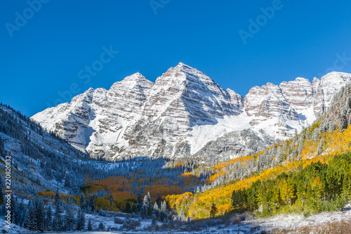 Close up Maroon Bells peaks with yellow aspen forest in Colorado