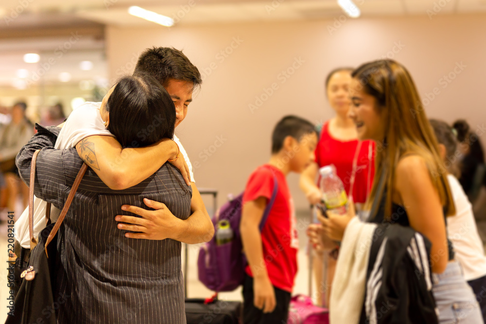 Happy  family young son hugging mother with sister smiling on ar