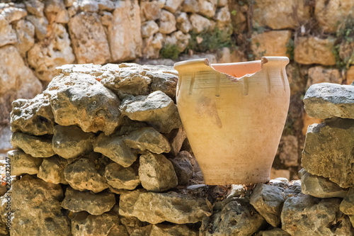 Old pot on an stone wall, archaeological park of Shiloh, Israel