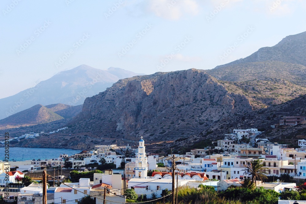 Obraz premium View of Arkasa village at dawn with the mountain headlands in the background on the island of Karpathos in Greece in the Mediterranean Sea
