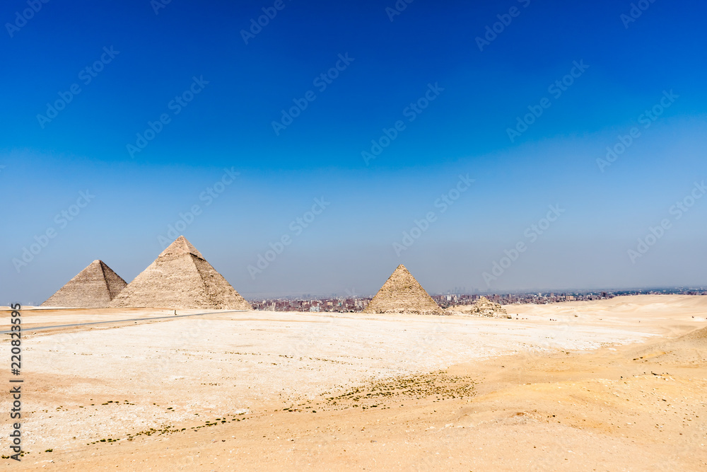 Egypt. Cairo - Giza. General view of pyramids from the Giza Plateau (from left: the Pyramid of Chufu /Cheops/, Khafre, Menkaure /Mykerinos/ and one of the small pyramids known as Queens' Pyramids)