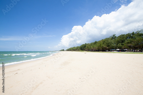 Beautiful sandy beach tropical sea and tree pine in Thailand. With big cloud on the sky.