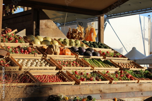 Fruits and vegetables at a sunny wooden market bench during sunset