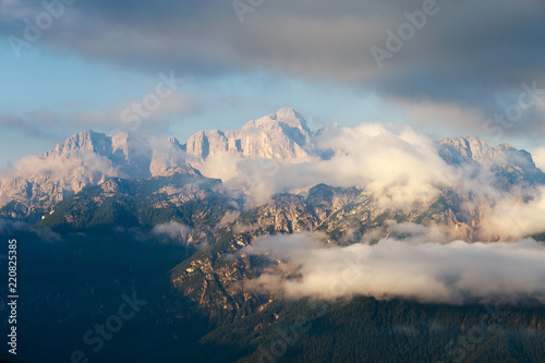 Magical dolomites mountains with snow and white clouds