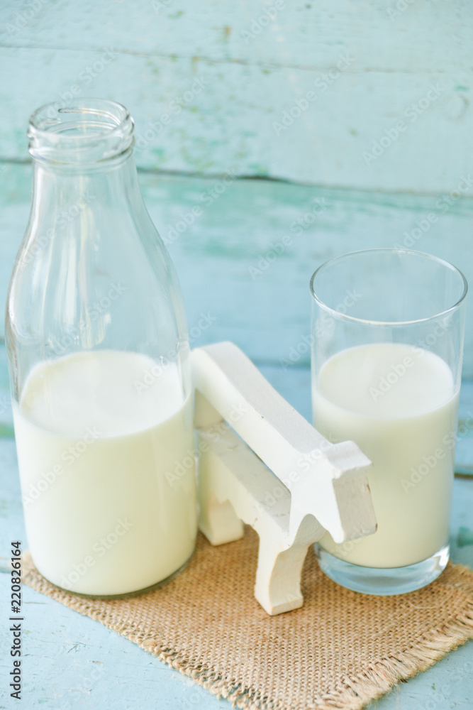 milk bottle, glass of milk, a figure of a cow the concept of rural food, fresh food milk bottle, glass of milk, a figure of a cow the concept of rural food, fresh food