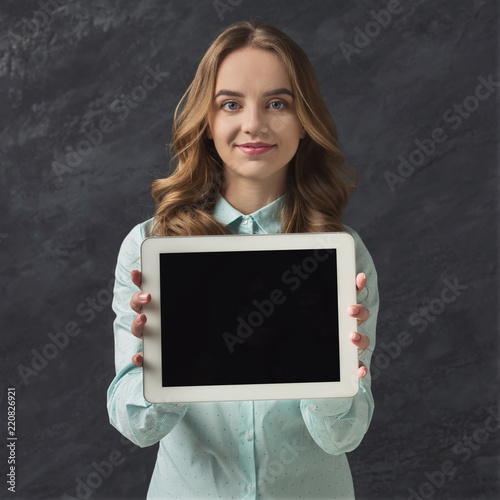 Beautiful woman with blank tablet in studio