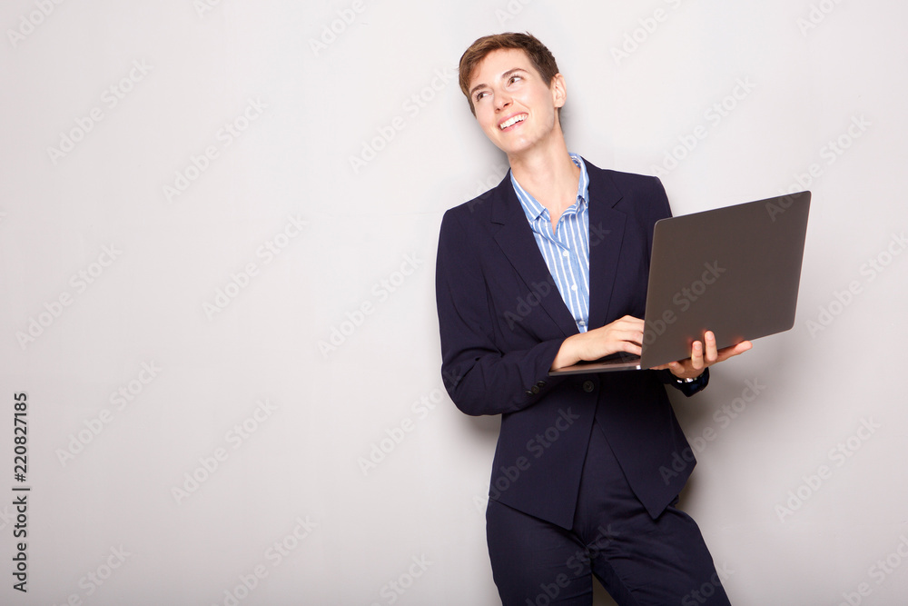 happy young businesswoman holding laptop computer happy young businesswoman holding laptop computer
