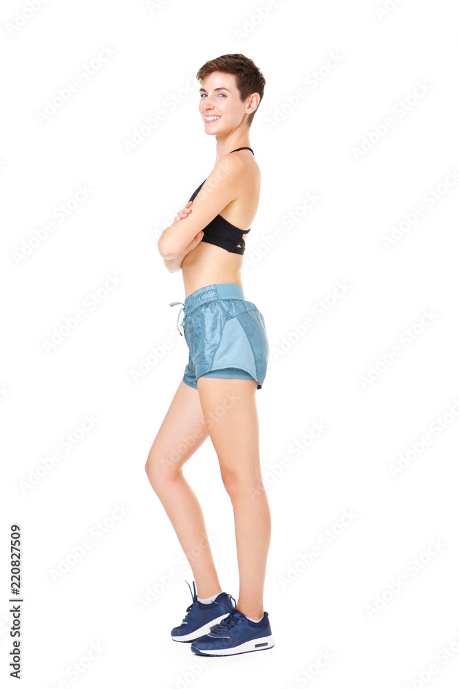 Full length happy exercise woman standing against isolated white background Full length happy exercise woman standing against isolated white background