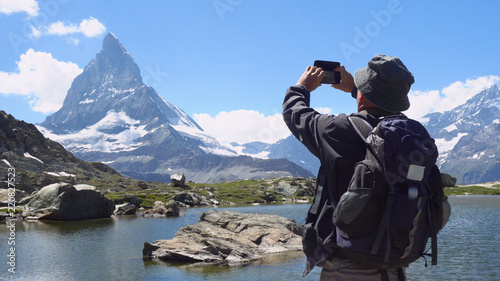 Old Man Taking Pictures With Mobile Smartphone Of Mountain and Landscape