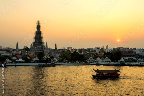 beautiful sunset wat arun temple and river cruise on chao phraya river, landscape Bangkok Thailand