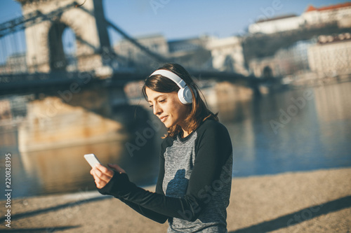 Young athlete woman with mobile phone outdoor