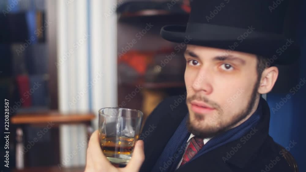 Portrait of attractive man in dark coat and trendy suit indoors tailors Portrait of attractive man in dark coat and trendy suit indoors tailors