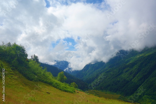 Hiking trail to Silver lakes with clouds around the mountains going via Tobavarchkhili from Mukhuri to Khaishi in Caucasus mountains  Georgia