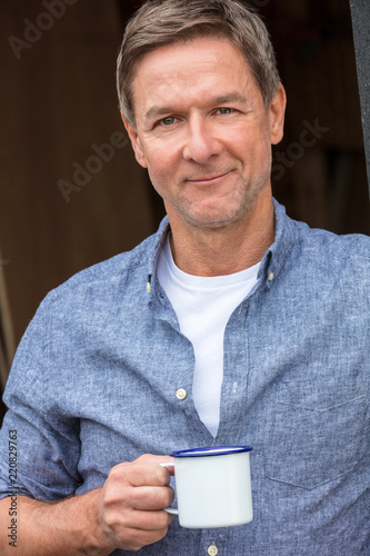 Happy Middle Aged Man Drinking Tea or Coffee Outside