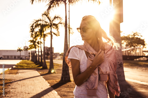 beautiful girl with sunglasses at sunset photo