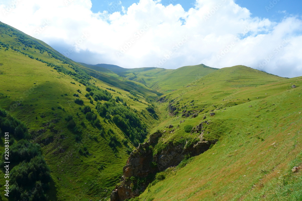 Mountain range on a hiking trail from Stepantsminda to Gergeti glacier continuing to mount Kazbek in Georgia