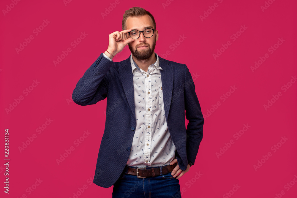 Studio shot of attractive brunette business man with glasses, in casual shirt, stylish black jacket on pink background Studio shot of attractive brunette business man with glasses, in casual shirt, stylish black jacket on pink background